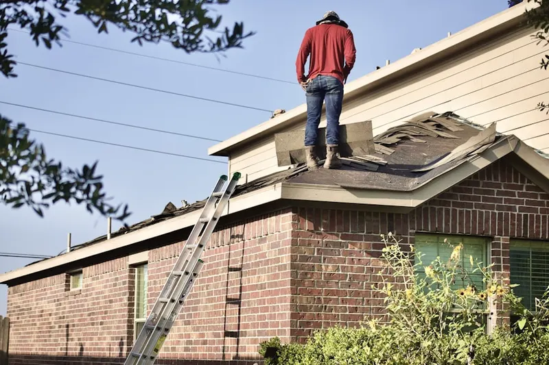 Professional roofer working on a residential roof in North Stelton